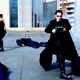 Trinity and Neo fight on a roof.